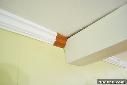 Salvaged piece of old, orange-toned crown molding found for matching