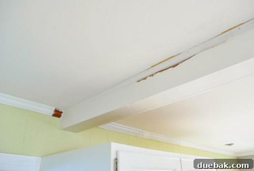 Finished crown molding, caulked and painted, showing transition between trim types