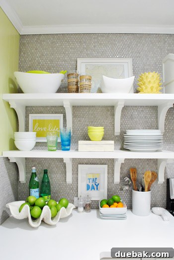 Close-up of styled open kitchen shelves, highlighting decor and frames