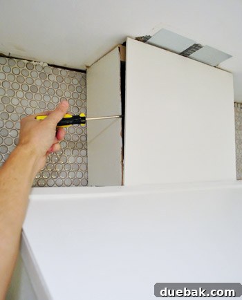 Removing old duct tape from a kitchen range hood vent