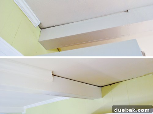 Kitchen ceiling showing a mismatched thick crown molding on one beam