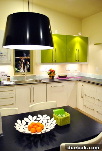 Kitchen in Ideabox prefab home featuring bright green cabinets adding a pop of color
