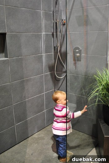 Clara taking a playful faux shower in a display bathroom at the Home & Garden Show