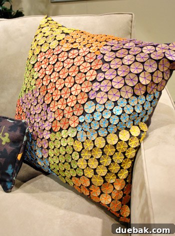 Decorative pillows with polished cork-like wood disks and colorful thread