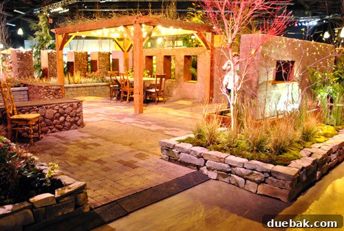Vibrant indoor landscaping display at the Home & Garden Show with lush plants and mood lighting