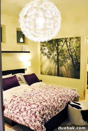 Bedroom interior of the Ideabox prefab home, featuring an Ikea light fixture