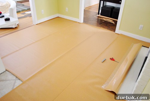 Underlayment being installed around a fireplace