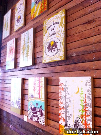 Display of various letterpress art prints on wood boards at Pine State Biscuits