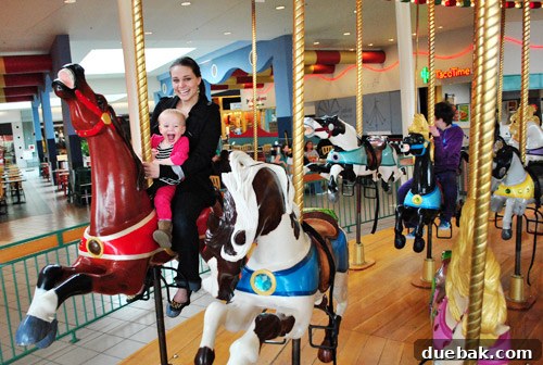 Clara enjoying a carousel ride, a highlight for toddlers in Portland