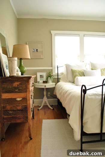 Guest room featuring a charming metal bed and an exceptionally cool, unique old wood dresser