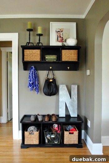 Charming entryway with custom-built storage solutions, an oversized 'N' initial, and elegant home decor