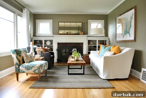 Working wood-burning fireplace in the living room, adorned with a patterned Crate & Barrel rug and a stylish Craigslist mirror