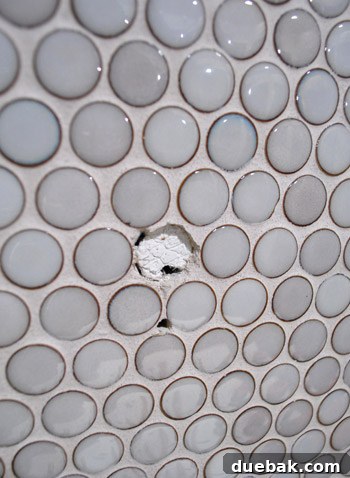 Flawless Penny Tile Repair 7 Tile removed, showing hole in grout