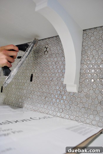 Flawless Penny Tile Repair 9 Applying grout to new tiles