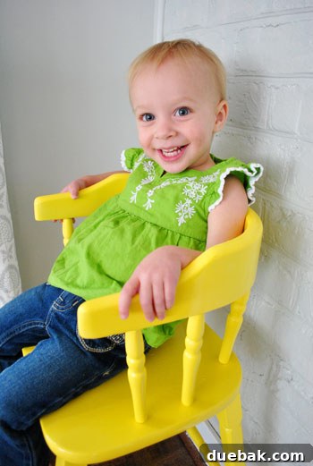 Giving an Old Wooden Highchair a Makeover 11 happy toddler in new yellow highchair