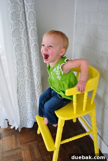 Giving an Old Wooden Highchair a Makeover 13 toddler singing in new yellow highchair