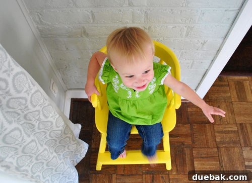Giving an Old Wooden Highchair a Makeover 17 toddler's feet on yellow highchair footrest