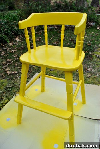 Giving an Old Wooden Highchair a Makeover 8 highchair with solid yellow spray paint coverage