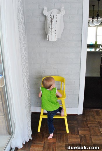 Giving an Old Wooden Highchair a Makeover 10 toddler trying to climb into new highchair