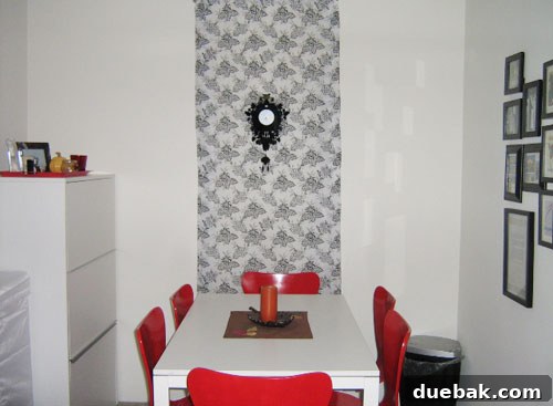 Evelyn's Dining Area After Makeover A transformed dining area after renovation, featuring a clean dining set, a hidden microwave in a cabinet, and a decorative cuckoo clock.