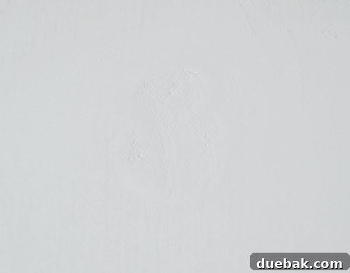 Spackled wall patch before sanding.