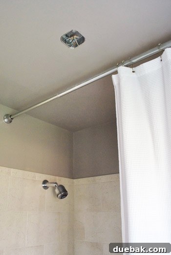 Upgrade Your Boob Light to a Modern Pendant 14 Renovated bathroom ceiling with the patched area painted, showing more space from the shower.