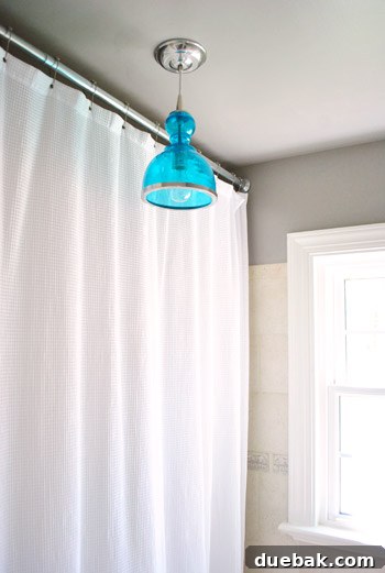 Upgrade Your Boob Light to a Modern Pendant 21 The newly installed blue seeded glass pendant light in the renovated bathroom.