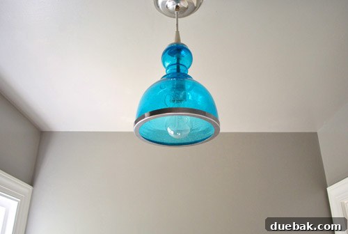Upgrade Your Boob Light to a Modern Pendant 22 View of the bathroom with the new light fixture, showing chrome accents.