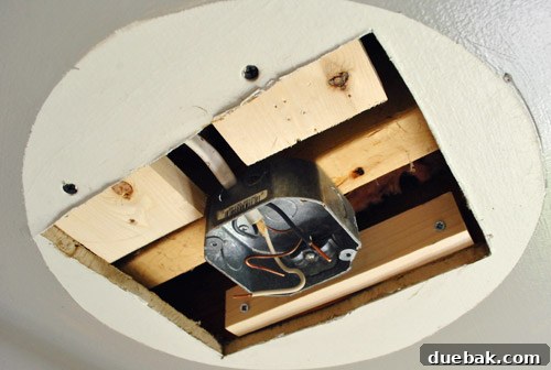 Upgrade Your Boob Light to a Modern Pendant 10 Scrap wood pieces screwed into the ceiling to support the drywall patch.