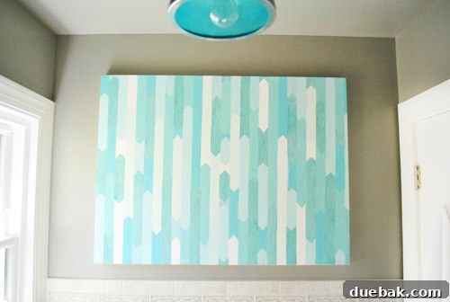 Bathroom Glow-Up on a Budget 2 Close-up of a blue and white abstract DIY canvas art piece, ready to be hung in a bathroom.