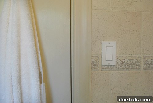 Bathroom Glow-Up on a Budget 10 Bathroom door and window trim in the original beige-y off-white color, looking dull.