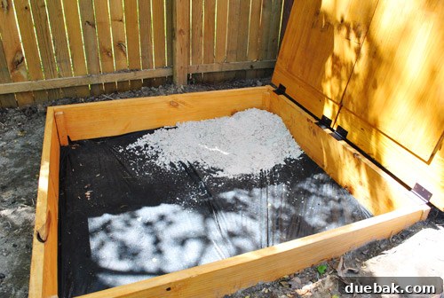 First bag of sand being poured into the empty sandbox