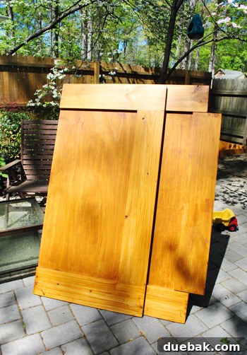 Stained wooden sandbox cover piece, showing the extended middle board