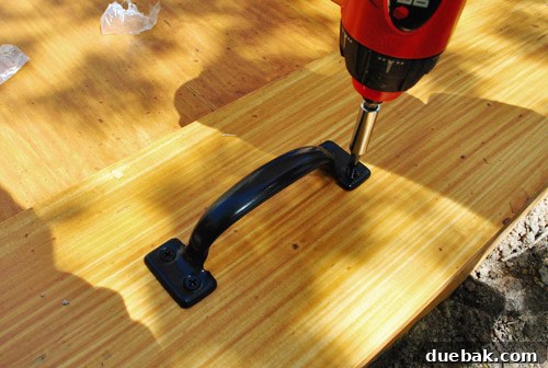 Matching handles installed on the sandbox cover for easy lifting