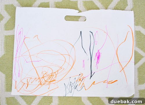 A photograph of Clara's artwork, taken straight-on, showing the colorful scribbles ready for digital processing.
