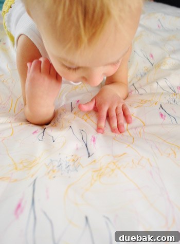 Clara sitting thoughtfully, looking at her custom fabric with a loving expression.