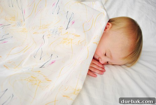 Clara's humorous expression when reminded that naps mean closing her eyes, while still under her fabric.