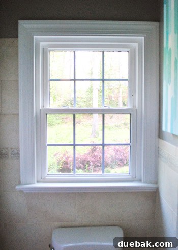 Before image of a bathroom window lacking privacy