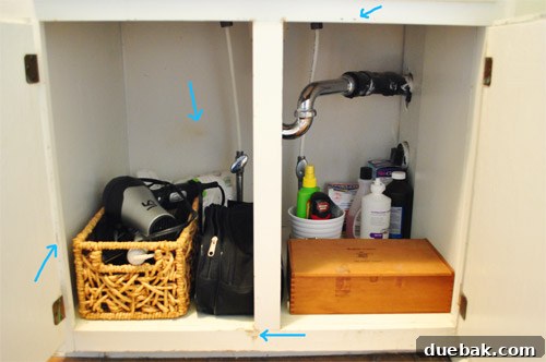 Clutter-Free Bathroom Drawers 9 Under-sink cabinet with minimalist storage, showing a travel bag and a basket
