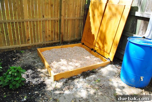 Rock box with lid open, revealing pea gravel