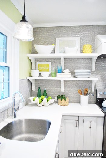 Seamless white Corian countertops with an integrated undermount sink, appearing clean, modern, and highly functional