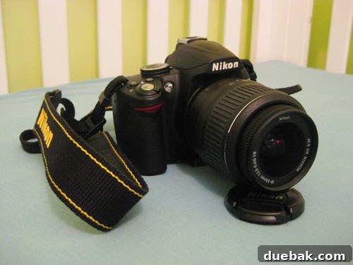 Nikon D3000 DSLR camera with a prime lens, used for capturing high-quality family and blog photos in various lighting conditions