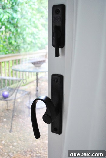 Exterior door handle with an oil-rubbed bronze finish, appearing new and resilient despite heavy usage