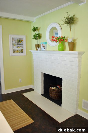An unfinished fireplace hearth with raw cork edges, waiting for transition trim to be installed.