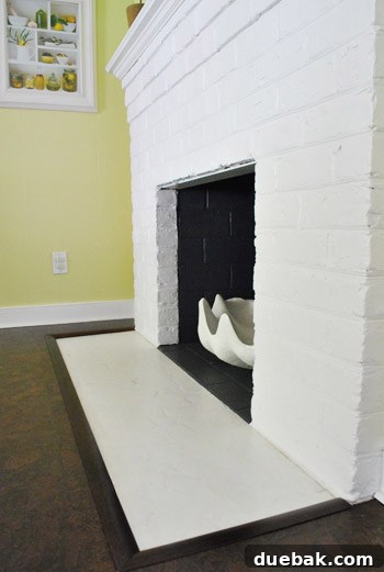 A close-up of the finished fireplace transition, showing the mitered corners and clean edges.