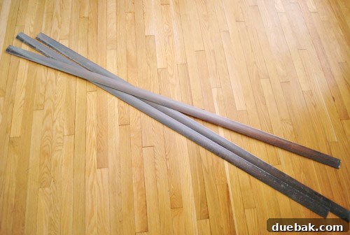 Close-up of an engineered wood transition piece, demonstrating its color match to cork flooring.