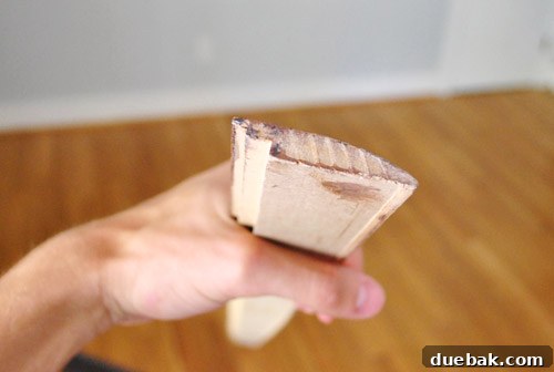 Close-up showing a reducer transition piece with its sloped profile, illustrating how it bridges different floor heights.