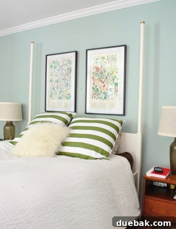 A closer view of the framed prints and the chandelier, showing the subtle overlap and layered effect.