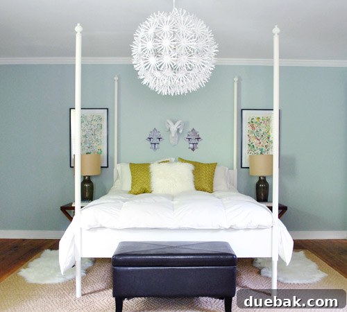 Bedroom decor showing two framed botanical prints hanging symmetrically above a bed with a white headboard, after their first makeover.