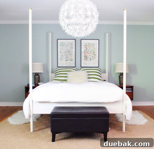 The two framed prints now positioned closer together above the bed, with a new, more cohesive arrangement.